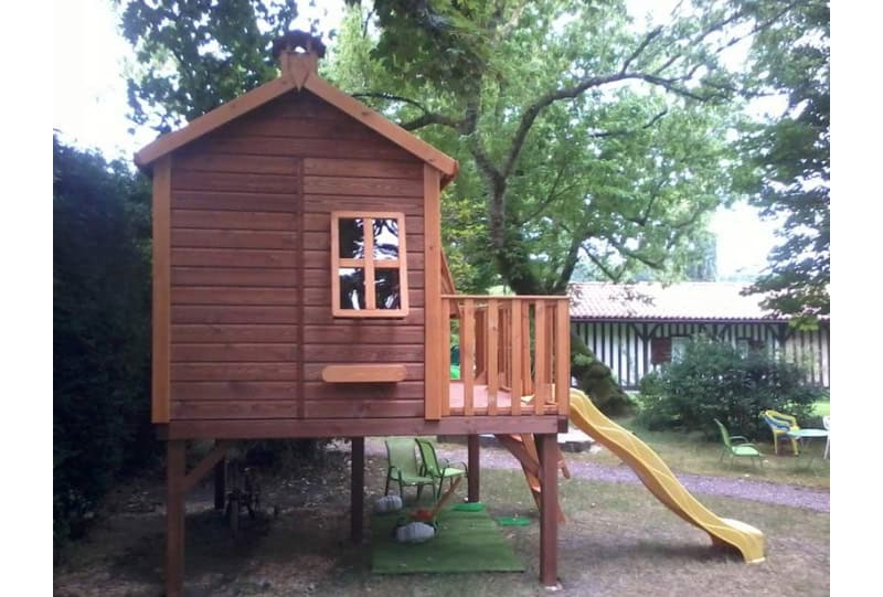 Enfants jouant dans une cabane en bois à l'extérieur